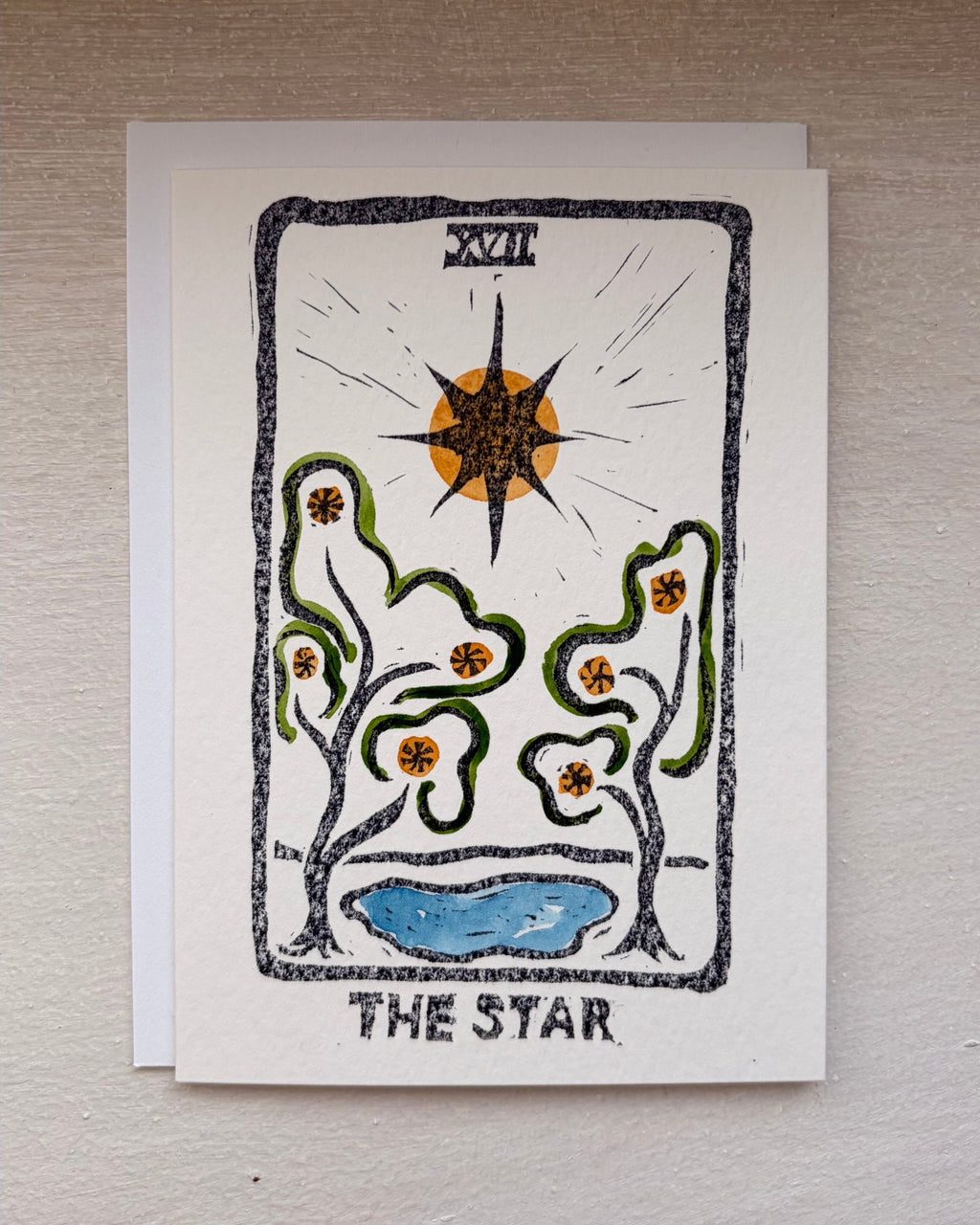 A tarot card titled 'THE STAR' with a hand-drawn style illustration, an envelope beneath.